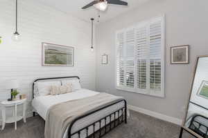 Bedroom featuring dark carpet and ceiling fan