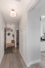 Corridor with light wood-type flooring