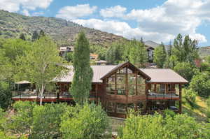 Rear view of house featuring a balcony and a mountain view