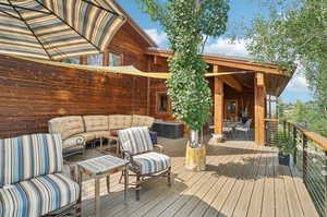 Wooden terrace featuring an outdoor living space