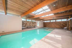 View of swimming pool with a skylight