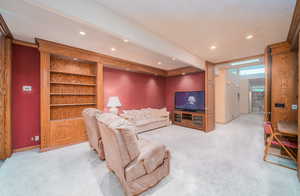 Carpeted living room with a textured ceiling and beam ceiling