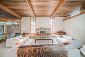 Living room with beamed ceiling and wooden ceiling