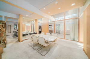 Carpeted dining area featuring a textured ceiling