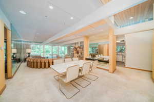 Dining area featuring light colored carpet