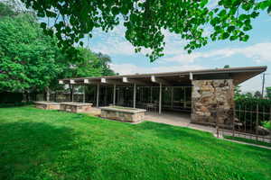 Rear view of house featuring a yard and a patio area