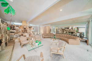 Carpeted living room with a textured ceiling