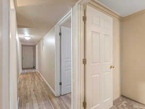 Corridor with light wood-type flooring