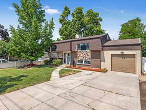 View of front of home featuring a garage and a front yard