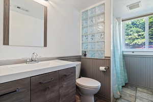 Bathroom featuring vanity, toilet, and tile patterned flooring