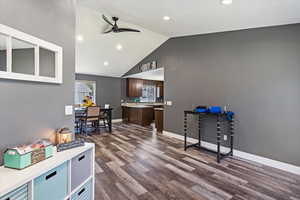 Office space with hardwood / wood-style flooring, high vaulted ceiling, and ceiling fan