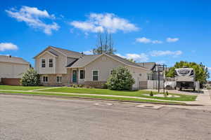 View of front of house with a garage and a front lawn