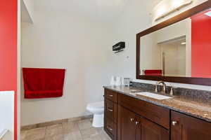 Bathroom featuring vanity, tile patterned floors, and toilet