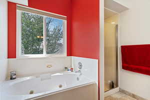 Bathroom featuring plus walk in shower and tile patterned flooring