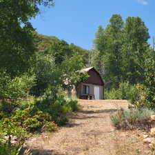 View of front of home with a garage and an outdoor structure