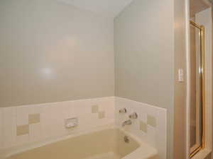 Bathroom featuring shower with separate bathtub