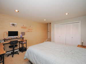 Carpeted bedroom featuring a closet