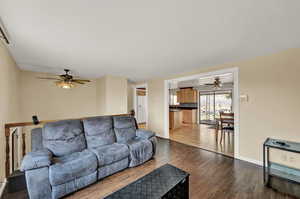 Living room featuring ceiling fan and hardwood / wood-style flooring