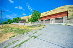 View of front of home with a mountain view and a garage