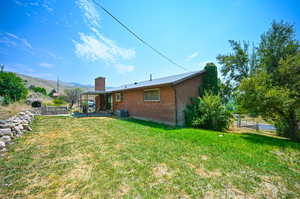 View of yard with a mountain view and central AC unit