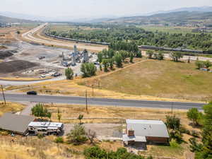 Birds eye view of property with a mountain view and a rural view