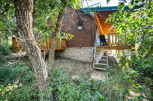 View of property exterior featuring a deck