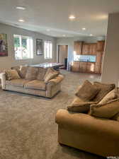 View of carpeted living room with wet bar