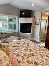 Carpeted bedroom featuring lofted ceiling