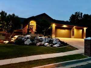 View of front of property with a garage and a front yard