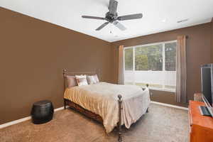 Bedroom featuring light colored carpet and ceiling fan