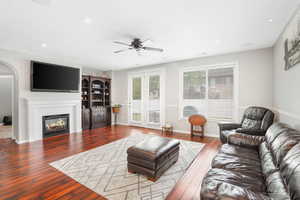 Living room with wood-type flooring and ceiling fan