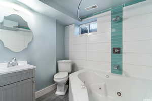 Bathroom featuring hardwood / wood-style floors, toilet, and vanity