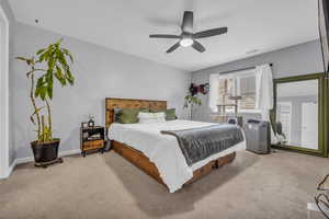 Bedroom with light carpet and ceiling fan