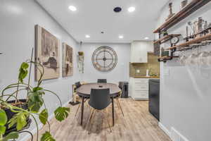 Dining space with light hardwood / wood-style floors and sink