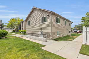 View of side of home featuring a yard