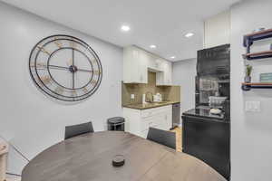 Dining area featuring sink and light hardwood / wood-style flooring