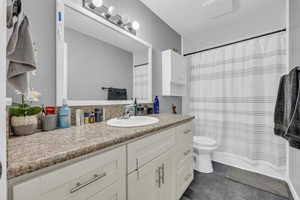 Bathroom with vanity, tile patterned flooring, and toilet