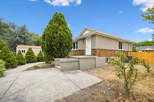 View of side of home in the backyard