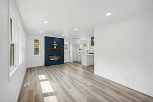 Unfurnished living room with a fireplace and light hardwood / wood-style flooring