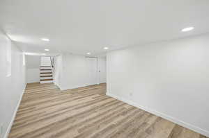 Basement living room with light wood-type flooring