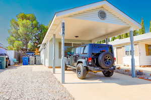 View of parking with a carport