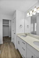 Bathroom featuring dual bowl vanity and hardwood / wood-style floors