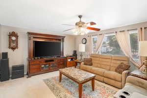 Large Living room featuring light colored carpet and ceiling fan