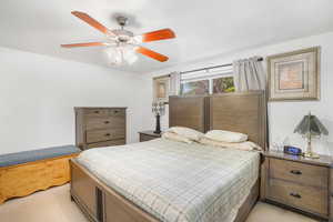 Bedroom featuring light colored carpet and ceiling fan