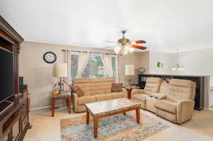 Large Living room with ceiling fan and light colored carpet