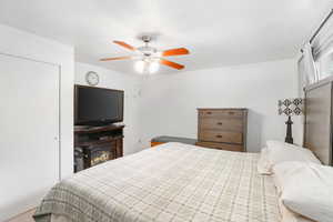 Carpeted bedroom with ceiling fan