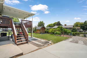 View of patio featuring a storage shed, central AC, large covered deck, and RV parking