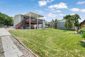 View of yard with fruit trees and large covered deck