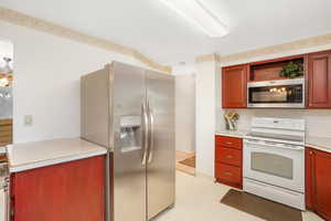 Kitchen with stainless steel fridge and white appliances