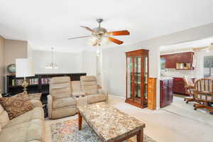 Large Living room with light carpet and ceiling fan